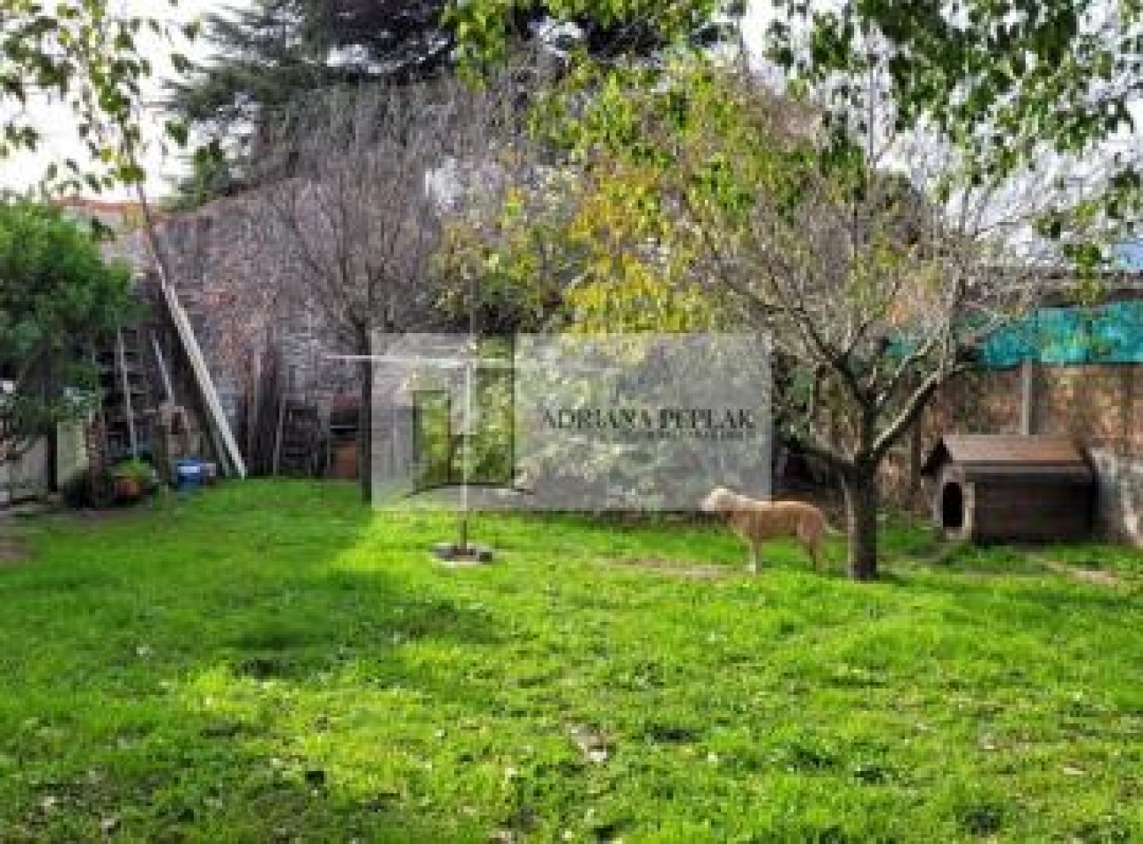 LOTE EN BURZACO A MTS, DE LA AV. 2 DE ABRIL. PARQUIZADO, CON PAREDON Y PORTON DE GARAGE.